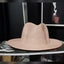 Beige straw hat on a black surface with a blurred background
