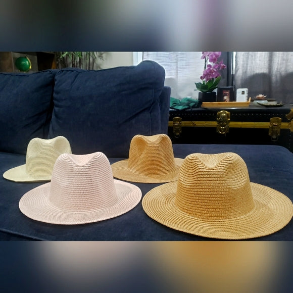Four straw fedora hats in different colors 