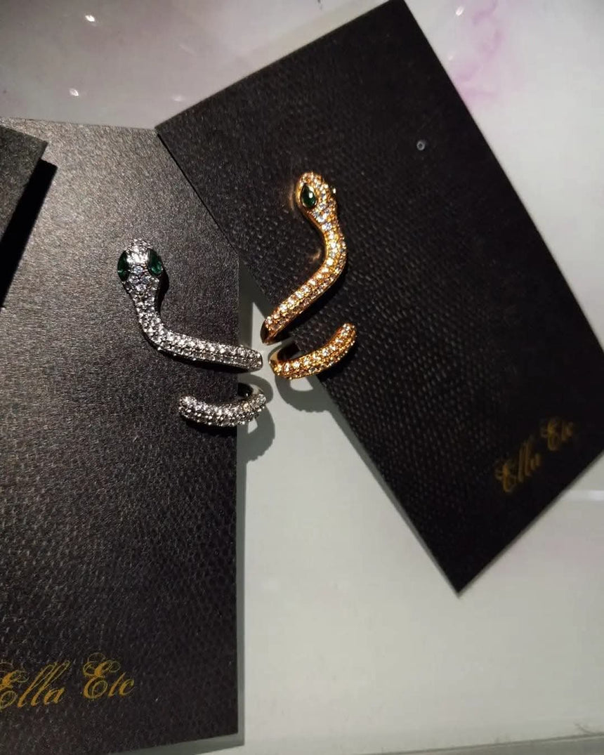 Gold and silver pavé snake stud earrings with green jeweled eyes for pierced ears, sold individually